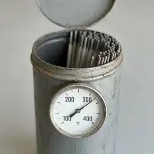 Open portable rod oven with 7018 rods inside and its thermometer at 300°F